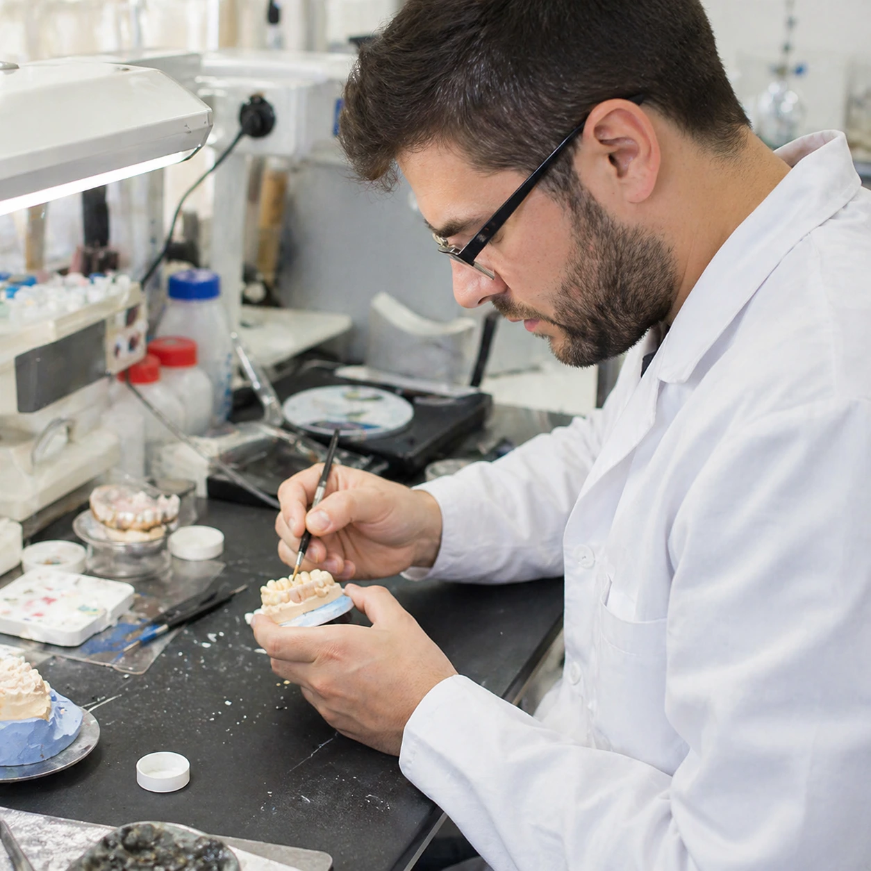 Qualified dental technician crafting retainers in our UK lab